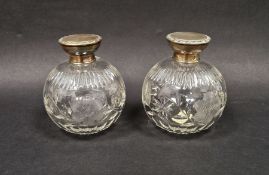 Pair of George V silver mounted cut glass perfume bottles, each with floral decoration, hallmarked