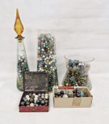 Large quantity of marbles of various sizes and colours, one within a mid-20th century decanter