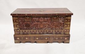 19th century hardwood brass-bound coffer with ornate carved foliate decoration to the front, the lid
