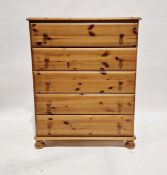 Contemporary pine chest of drawers, comprising five long drawers, raised on bun feet, 107cm high x
