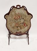 Victorian mahogany firescreen with embroidered tapestry scene depicting flowers and leaves on one