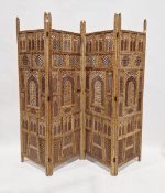 20th century Indian carved wood four panel folding screen, with pierced fretwork arched panels, each