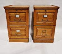Pair of modern two-drawer oak filing cabinets, each with keys, 71cm high x 41cm wide x 45cm deep (2)