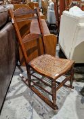 Cane seated rocking chair, circa 1890, with arched foliate carved top rail and splat before cane