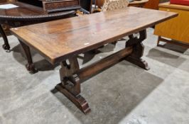 20th century stained oak refectory table, with plank top above twin heart shaped and scroll supports