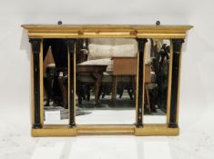 Regency giltwood overmantel mirror, of canted rectangular triparte form, the moulded cornice above