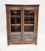 20th century oak two-door glazed display cabinet, the doors opening to reveal three adjustable