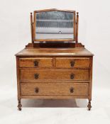 Early 20th century oak dressing table chest with fitted bevelled edged swing mirror, the chest