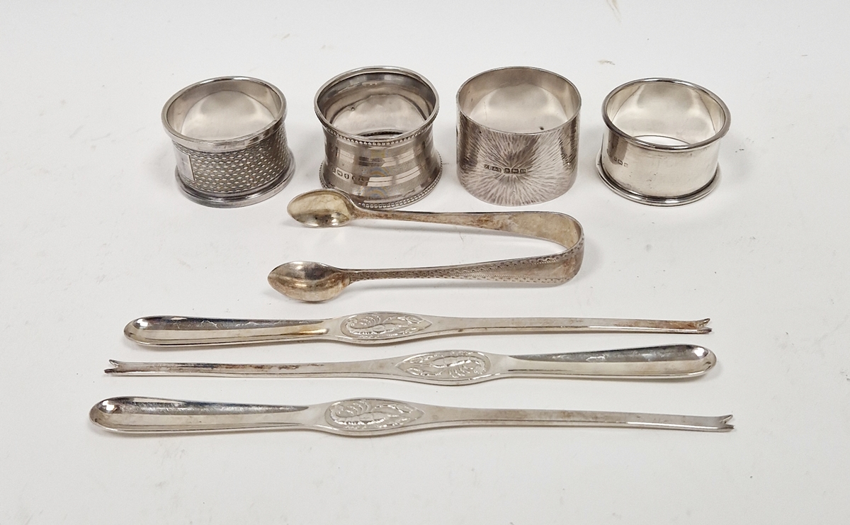 Four silver napkin rings, pair silver sugar nips with bright cut decoration, and three Swedish