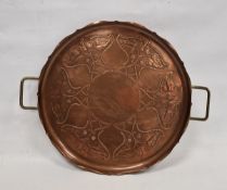 J.S & S Art Nouveau copper two-handled circular tray, cast with fruiting vine and whiplash motifs,