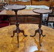 Two Georgian-style mahogany wine tables, each with tapering gadrooned column support, on tripod