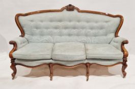 Victorian walnut-framed button back salon suite, comprising a three-seater sofa and a pair of