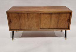 Mid century teak storage unit with sliding doors opening to reveal a storage compartment and a vinyl