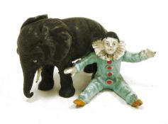 Cold painted lead group of a circus clown seated beside an elephant, early 20th century, the clown