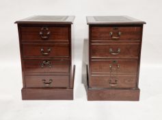 Pair of 20th century stained oak veneer filing cabinets, each with gilt tooled leather insert to the