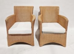 Pair of 20th century Lloyd Loom wicker armchairs each with removable seat cushion, 82cm high approx.