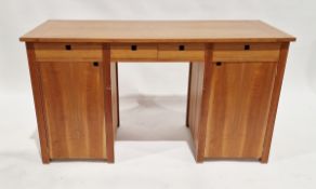 20th century twin-pedestal cherry wood desk having four short drawers with a single door cupboard on