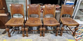 Set of four carved oak early 20th century dining chairs, each upholstered in studded tan brown