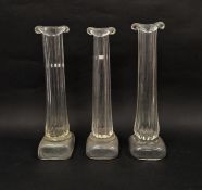 Three Patrick Stern clear glass vases in the form of columns on plinth bases, each signed to base,