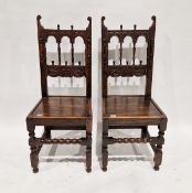 Pair of late 19th/early 20th century stained oak hall chairs, with spindle arched pierced backs,