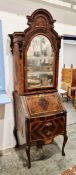 18th century Italian walnut bureau bookcase, the arched top with elaborate surmount, enclosed by