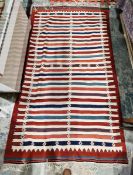 Persian kilim rug, woven with stripes in red, blue, manganese and green, on a cream ground and