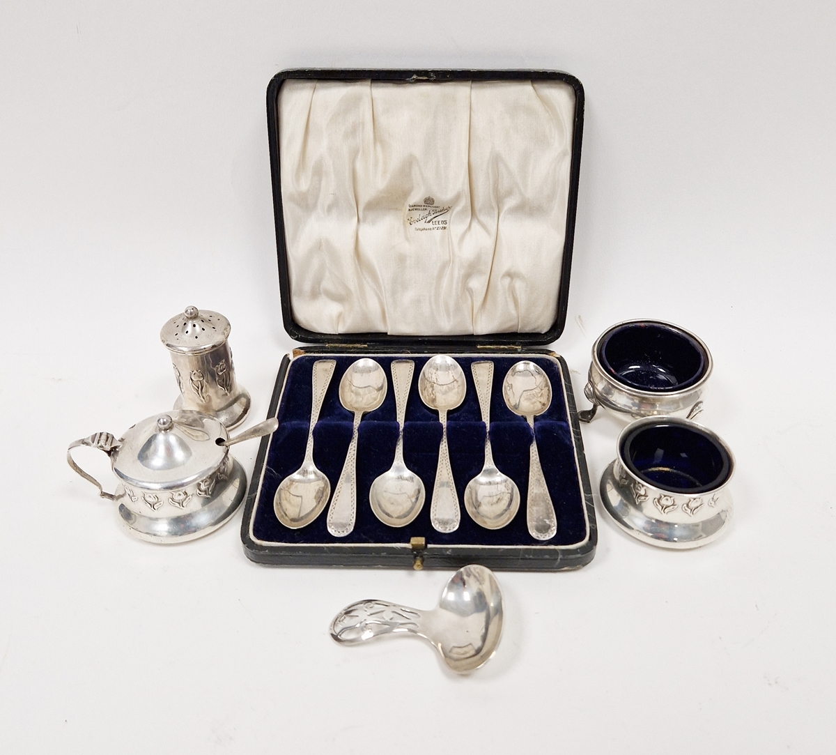 Edwardian silver three-piece condiment set, tulip decorated, Birmingham 1908, a silver caddy spoon