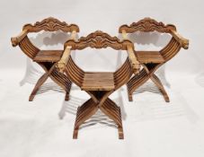 Set of three Savonarola folding chairs, each with carved wooden handle ends depicting lions faces,