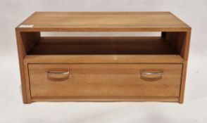 Contemporary adjustable television unit with extending top, raised over a storage shelf and a single