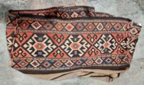 Caucasian carpet bag or cover, woven with lozenge-shaped ornament in black, brown, orange on a red