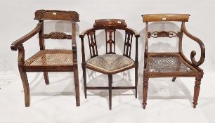 Two 19th century mahogany caned dining chairs, the first carved with palmettes and with scroll arms,