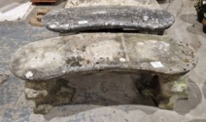 Pair of kidney-shaped reconstituted stone garden seats on lions head decorated supports, 118cm x