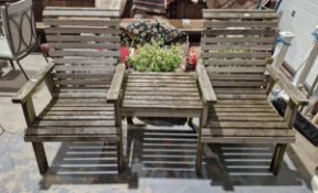 Two teak garden seats with fitted table between as a tete-a-tete bench