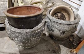 Two reconstituted stone planters decorated with swags and bunches of grapes and two glazed