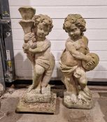 Two reconstituted garden figures in the form of cupid, one holding a torch, the other cymbals,