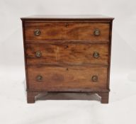 A Georgian mahogany chest of drawers comprising three long drawers each with two brass ring-pull