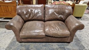 Laura Ashley 'Fairmont' two-seater brown leather sofa, with scroll arms, drop-in cushions and wooden