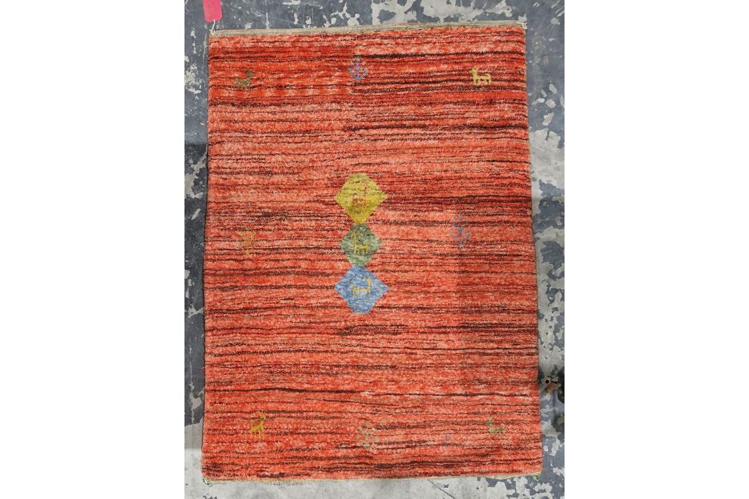 Peruvian style red ground rug with brown stripes decorated with three central coloured lozenges