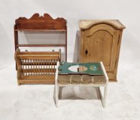 A stripped pine cupboard the single door opening to reveal two adjustable shelves raised over two