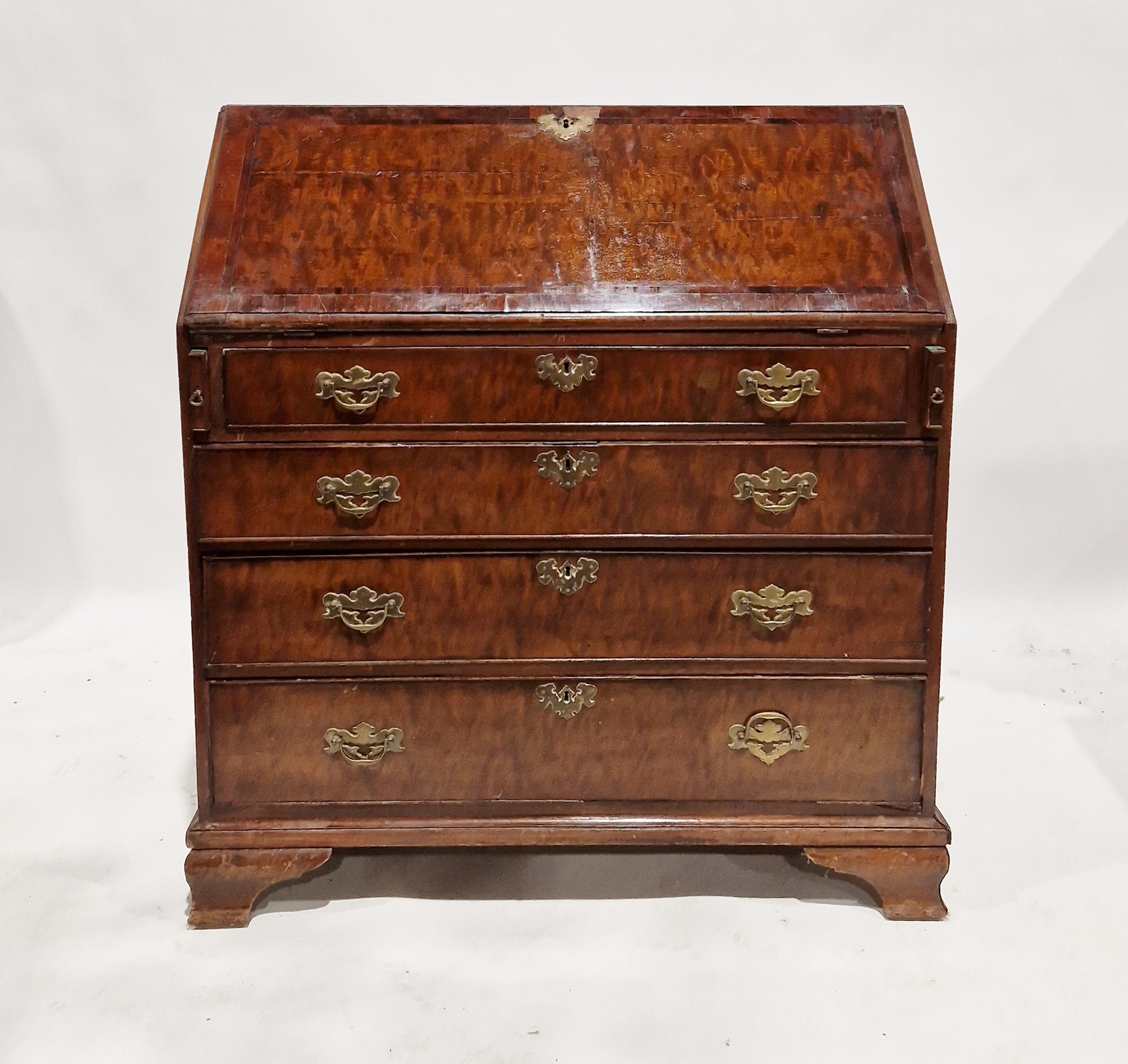 A Georgian mahogany bureau, the full front opening to reveal a blue gilt leather inset top and an