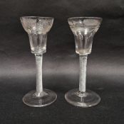 Two mid-18th century engraved airtwist wine glasses, each pan topped example engraved, the first