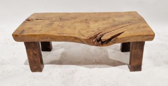 A contemporary naturalistic coffee table of rectangular form formed out of a single plank of wood,