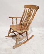A 20th century wooden rocking chair, measuring approx 110 cm high