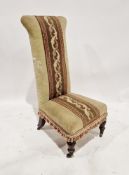 Late 19th/early 20th century upholstered prie-dieu, raised on front turned legs with castors,