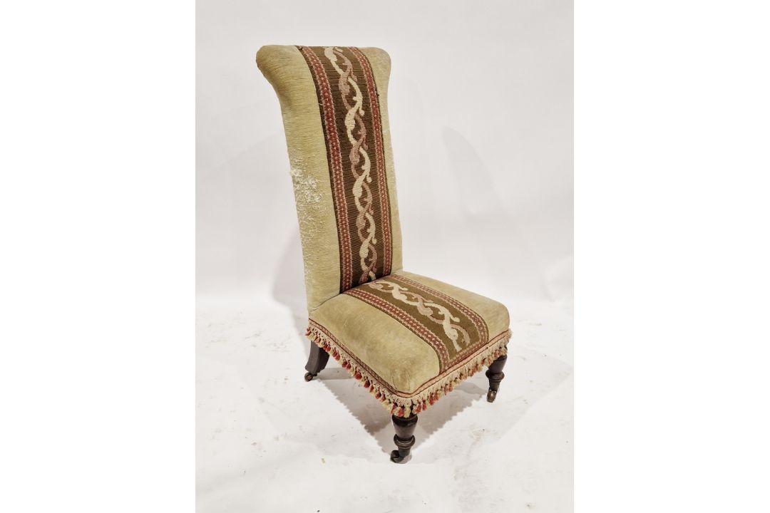 Late 19th/early 20th century upholstered prie-dieu, raised on front turned legs with castors,