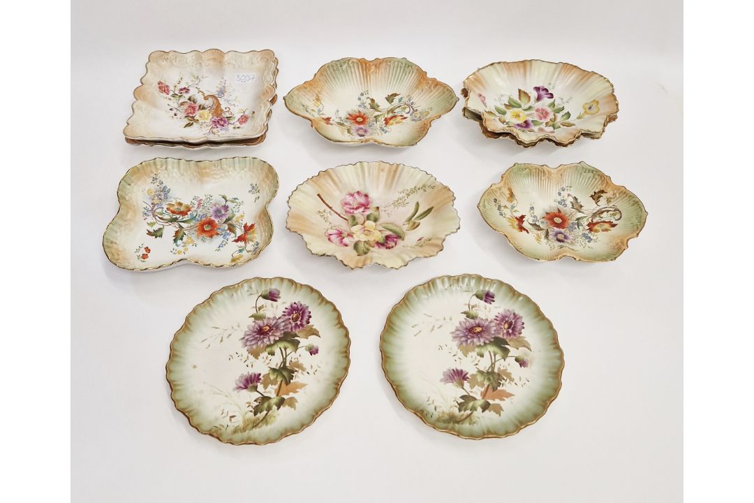 A Carlton Ware blush ivory ground part dessert service, printed marks, all with floral decoration (