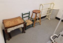 A green painted 20th century child's chair decorated with scenes of soldiers and drums, with the