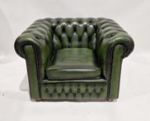 A 20th century green leatherette upholstered button backed club style armchair measuring approx 67