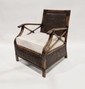 A contemporary stained wooden bamboo effect armchair with detachable seat cushion, measuring
