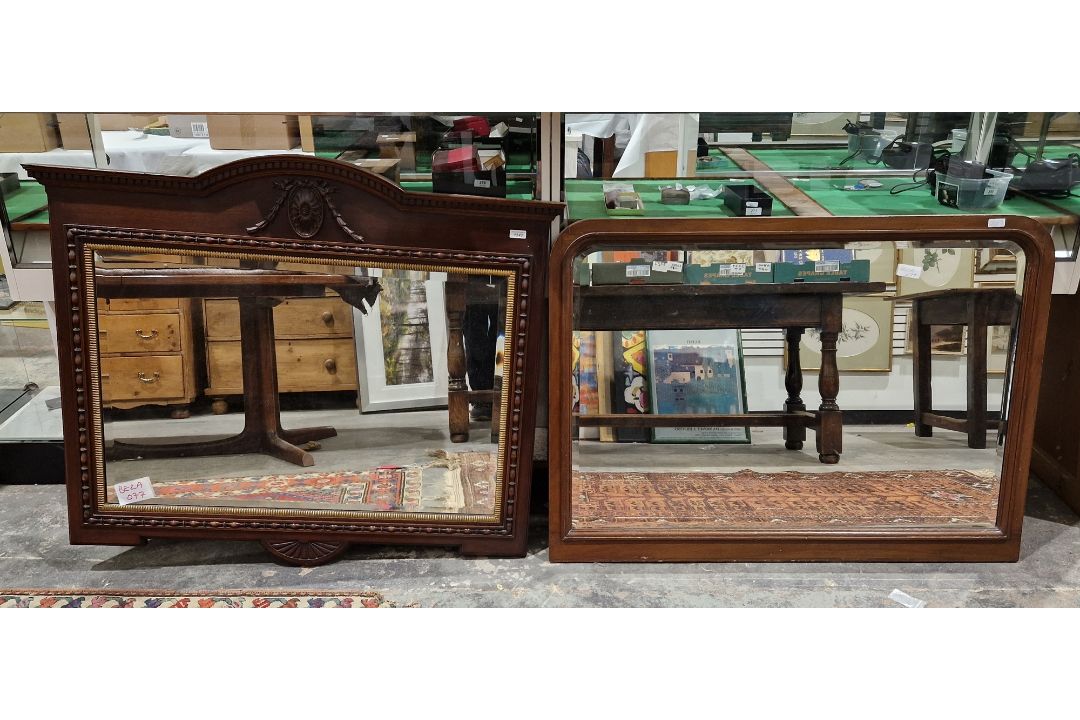 Oak framed wall mirror with bevelled plate, the frame with arched top, carved swag and scalloped